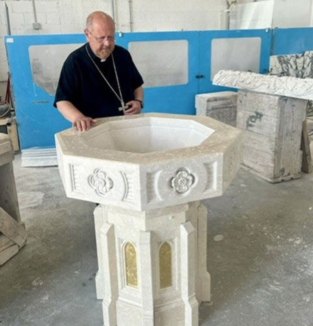 Bishop malesic with baptismal font